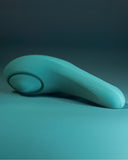 Hot Octopuss Queen Bee Pulsing Vibrator laying sideways on teal background 