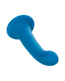 Blue slime splatted, stretching and forming a unique wavy pattern on a plain light blue background, hinting at the flexibility similar to that of a CalExotics Wave Rider Ripple First Time G-Spot and Prostate Silicone Dildo.