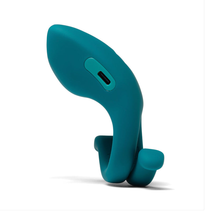 The Dame Hug Adjustable Vibrating Cock Ring for Couples is a teal silicone ring with two loops, a smooth curved surface, and a charging port, shown on a white background.