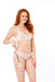 A smiling woman with long red hair in white lingerie stands against a white background, holding the Peaches 'n Cream Impressions Crop by her side.