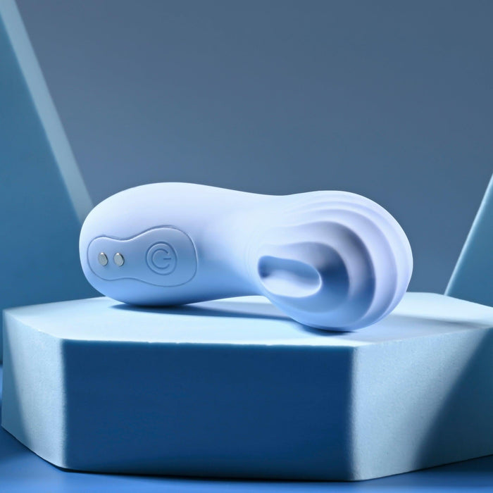 The Good Point G Spot Finger Vibrator, in white and featuring a curved, flexible design with a textured surface and control buttons, is elegantly showcased on a geometric blue podium against a dark blue backdrop, exuding precision and style.