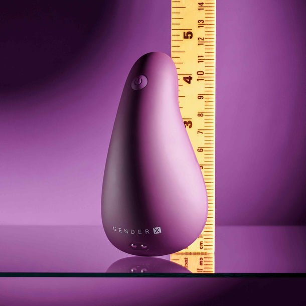 Compact, smooth purple silicone vibrator with power button, next to a ruler showing its 3.5-inch height.
