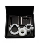 A black box containing various white and silver dental equipment including two handles, a mirror attachment, and several probes, arranged neatly in a foam insert.