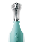 Electric turquoise Jimmyjane Focus Pro Pinpoint Tip Clitoral Vibrator with 2 Head Attachments, blending an invisible substance, isolated on a white background.