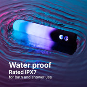White LED bullet vibrator glowing blue and purple, partially submerged in water.