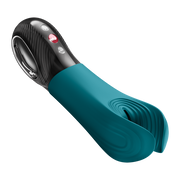 Teal silicone Fun Factory Manta penis stroker with black handle, silver accents, and red power button.