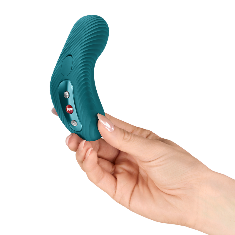 Hand holding a teal, curved Fun Factory Laya vibrator with ribbed texture and control buttons.