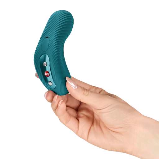 Hand holding a teal, curved Fun Factory Laya vibrator with ribbed texture and control buttons.