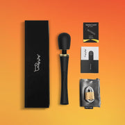 Tracy's Dog Hammer Wand, a black silicone vibrator with gold accents, packaging, and accessories.