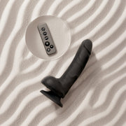 Black rotating vibrating realistic dildo with remote control on a textured surface.