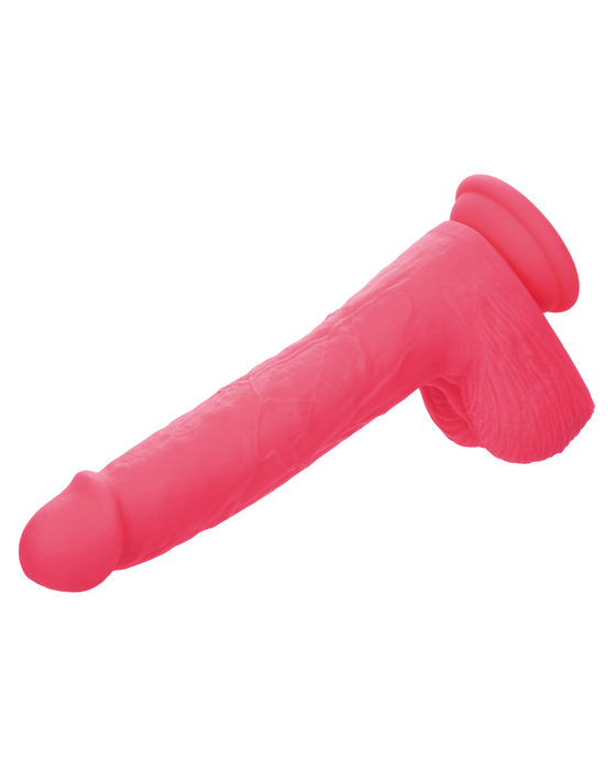 A pink, realistic-looking vibrating dildo made of silky silicone, featuring a suction cup base for hands-free use, and designed to be waterproof for added versatility is the Silicone Stud Rumbling & Thrusting 9.5 Inch Pink Dildo from CalExotics.