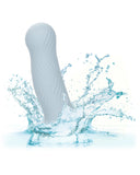 A clear, blue liquid silicone splash surrounding a Wave Rider Foam Short, Girthy 4.75 Inch Liquid Silicone Dildo with an elegant design, isolated on a white background. The liquid appears dynamic and fresh. (Brand Name: CalExotics)