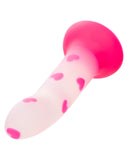A pink and semi-transparent Glow Stick Heart Silicone First Time Glow in the Dark Dildo with heart-shaped designs inside, isolated on a white background. (Brand: CalExotics)