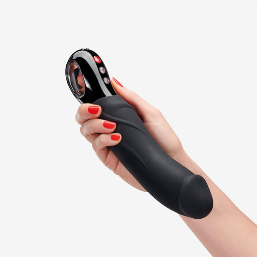 Hand holding a black silicone Fun Factory Big Boss G-Spot Vibrator with red control buttons.