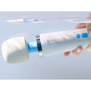 A hand holds the white Magic Wand Waterproof Rechargeable Cordless Vibrator, partially submerged in clear water, showcasing the powerful vibrator's true waterproof capabilities.