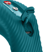Close-up of a teal silicone vibrator with a ribbed texture, showing the charging port and control buttons.
