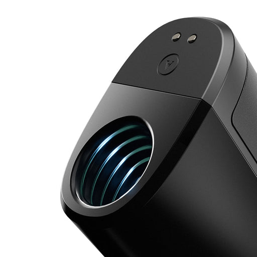 Close-up of the sleek, black Arcwave Ion 2 Penis Masturbator with Pleasure Air Suction, featuring a circular illuminated lens and two small buttons. Its modern minimalist design delivers an elevated pleasure experience.