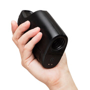 A hand holds the Arcwave Ion 2 Penis Masturbator with Pleasure Air Suction, a sleek black stroker with an open circular end and two buttons near the base, shown against a white background.