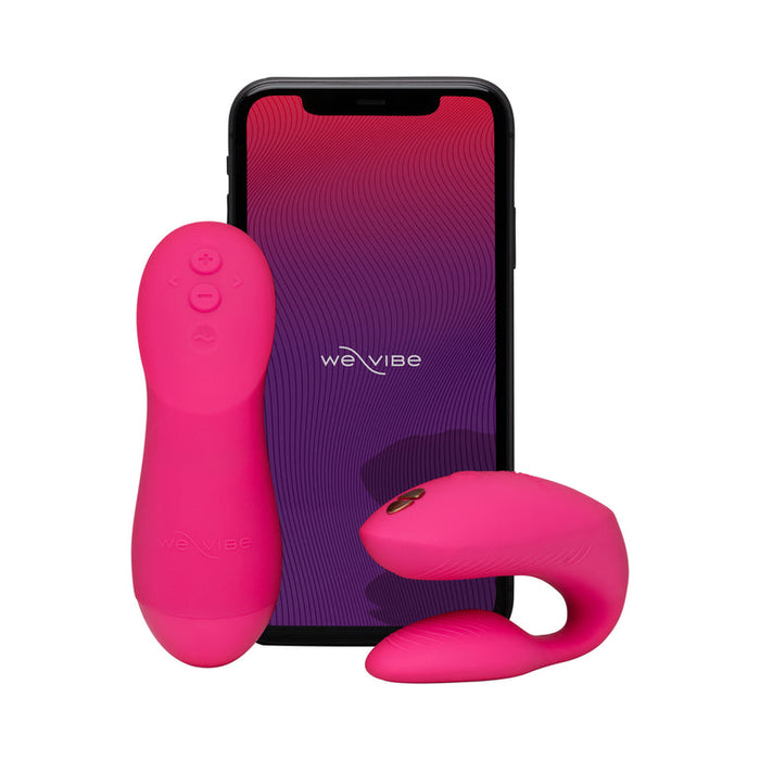 The We-Vibe Chorus Pro Wearable Couples' Vibrator with Triple Motors and remote control is shown in bright pink alongside a smartphone displaying the We-Vibe app interface, highlighting advanced G-spot stimulation on a white background.