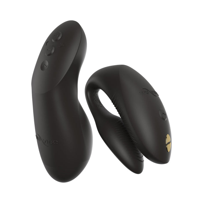 The We-Vibe Chorus Pro is a sleek, black, silicone wearable couples’ vibrator with triple motors for G-spot stimulation, gold accents, and a remote control with buttons; both feature the We-Vibe logo.