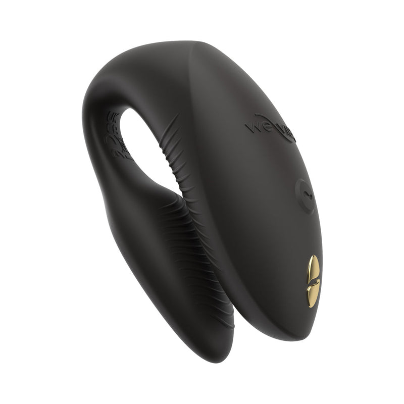 The We-Vibe Chorus Pro is a sleek, black, U-shaped silicone couples' vibrator with a gold accent and control button, featuring triple motors and remote control, designed for intimate G-spot stimulation.