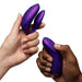 Two hands hold the We-Vibe Chorus Pro Wearable Couples' Vibrator with triple motors and its matching remote against a white background, showcasing its modern design and intimate G-spot stimulation for partners.