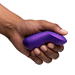 A hand holds the We-Vibe Chorus Pro Wearable Couples' Vibrator, a small, purple, curved device with triple motors designed for G-spot stimulation, photographed against a white background.
