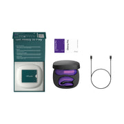 An open box with a teal interior displays the We-Vibe Chorus Pro Wearable Couples’ Vibrator with Triple Motors & Remote in a black charging case, two instruction booklets, and a black USB charging cable on a white background.
