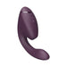 The Womanizer Next Duo Pleasure Air + Vibration Blended Orgasm Stimulator is a purple silicone device with a curved, ergonomic design, three control buttons, and a rounded tip, shown on a white background.