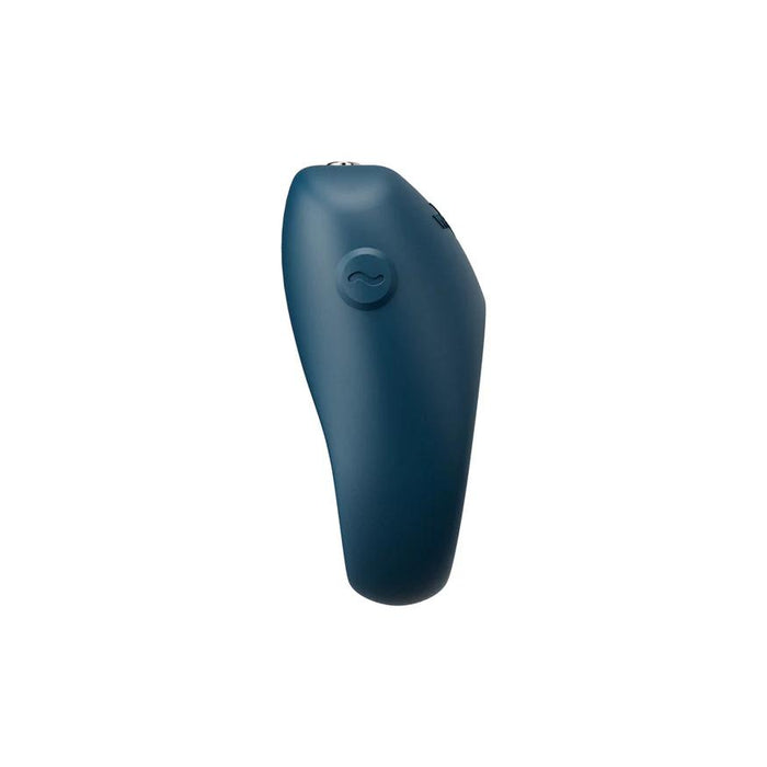 A dark blue, curved We-Vibe Pivot 2 Vibrating Silicone Rechargeable Penis Ring with a side button is displayed against a plain white background.