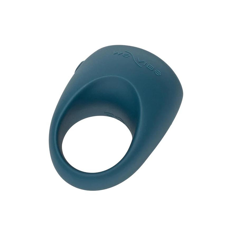 The We-Vibe Pivot 2 Vibrating Silicone Rechargeable Penis Ring is teal, with a rounded top, oval opening, and embossed “We-Vibe” logo, designed for hands-free clitoral stimulation.
