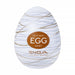 A discreet, white egg-shaped stroker with gold swirl patterns, labeled "Easy Beat Egg Silky." The Tenga Egg Standard 3 Pack Disposable Masturbators II features the TENGA brand and "Live With Wonder" slogan beneath the label.