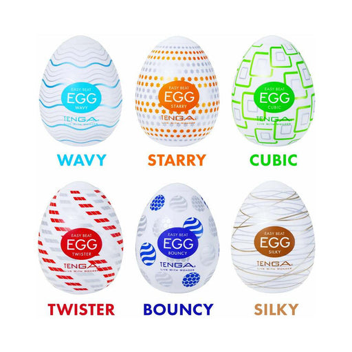 Six Tenga Egg Variety Pack Disposable Masturbators are displayed in two rows; each stretchable sleeve features a unique pattern, color, and label: Wavy, Starry, Cubic, Twister, Bouncy, and Silky.