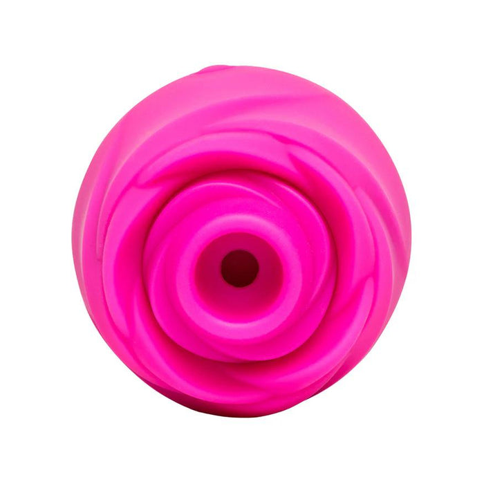 The Romp Rose 2 Pleasure Air Clitoris Stimulator in bright pink is a rose-shaped, rechargeable silicone toy with a central circular opening, designed for clitoral stimulation and shown from above against a white background.