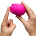 Two hands hold the Romp Rose 2 Pleasure Air Clitoris Stimulator in pink—a rechargeable, rose-shaped silicone toy with a small button—commonly used for clitoral stimulation, shown against a white background.