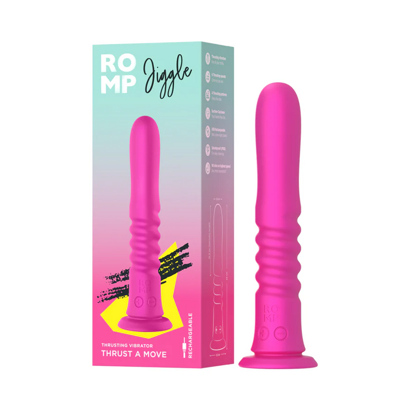 Pink silicone ROMP Jiggle thrusting vibrator with a ribbed shaft and suction base, next to its colorful product box.