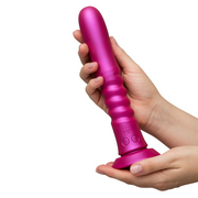 Pink ROMP Jiggle thrusting vibrator with a ribbed body, control buttons, and suction base, held by two hands.
