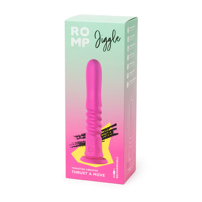 Pink silicone ROMP Jiggle thrusting vibrator with suction base, shown in its pastel green and pink retail box.
