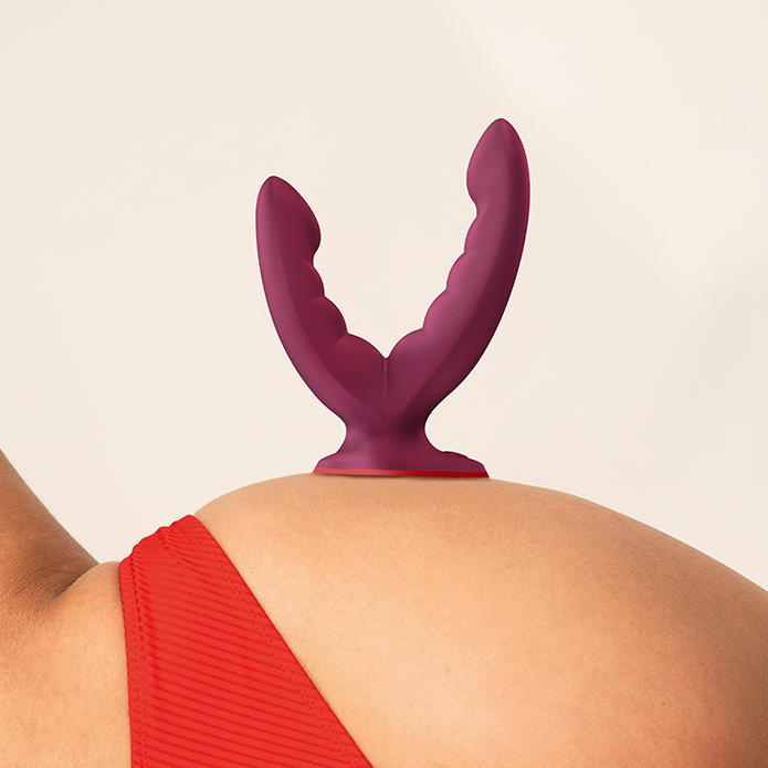 Purple silicone Fun Factory Ryde grinding dildo with a strong suction base on a person's skin.