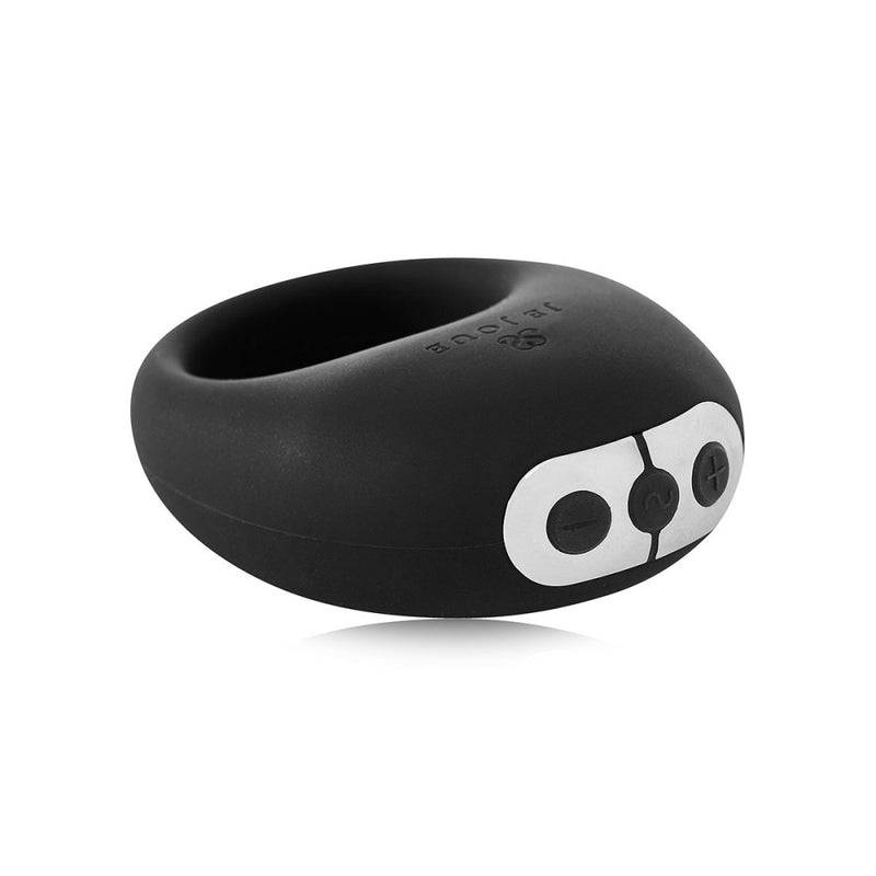 The Je Joue Mio Vibrating Cock Ring in black features a white control panel with plus and minus buttons, shown on a white background.