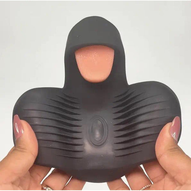 A person holds the Lickety Split Rechargeable Vibrating Thumping Stroker Silicone, a black curved device with textured ridges, a central opening, and a hooded top featuring a realistic flicking tongue design.