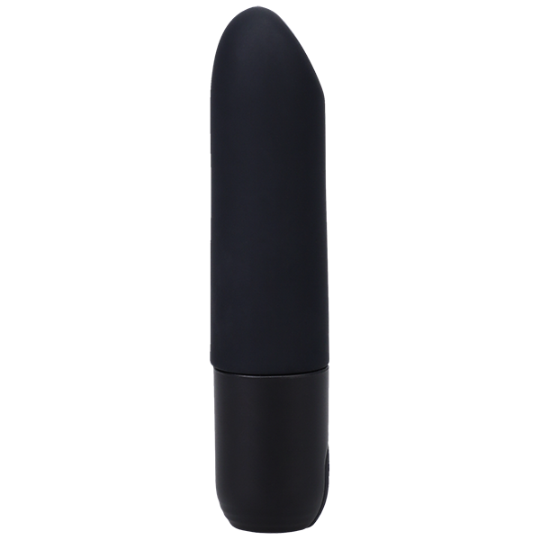 A black, cylindrical object with a slightly rounded tip, resembling a classic lipstick shape, stands vertically. The surface appears smooth and matte with no discernible markings or features; this is the Beginner Classic Black Silicone Bullet Vibrator In a Bag by Doc Johnson.