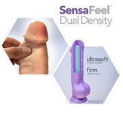 An image of a sex toy called the Big Boy 10 Inch Dual Density Suction Cup Dildo in Vanilla by Blush showcases its realistic design with an ultrasoft texture on the exterior and a firm, pliable core. One inset shows a hand gripping the dildo, highlighting its 10-inch dual density structure, while another inset illustrates the toy's flexible spine and strong suction cup base with labeled features.