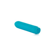 The Je Joue Powerful Classic Bullet with Finger Sleeve in teal is a compact, cylindrical vibrator with rounded edges and three raised buttons (+, –, O). USB rechargeable, it’s shown on a white background.