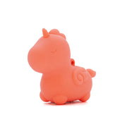 The Unihorn Mini - Peachy Pony Discreet Vibrator is a small, peach-colored unicorn figurine made of body-safe silicone, with a rounded body, closed eyes, short horn, and swirled tail, shown against a white background.