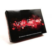 A black box labeled "You and Me - A Game of Love & Intimacy," adorned with red hearts and lights. The bottom reads: "90 bedroom challenges to deepen your connection—ideal for your next date night.