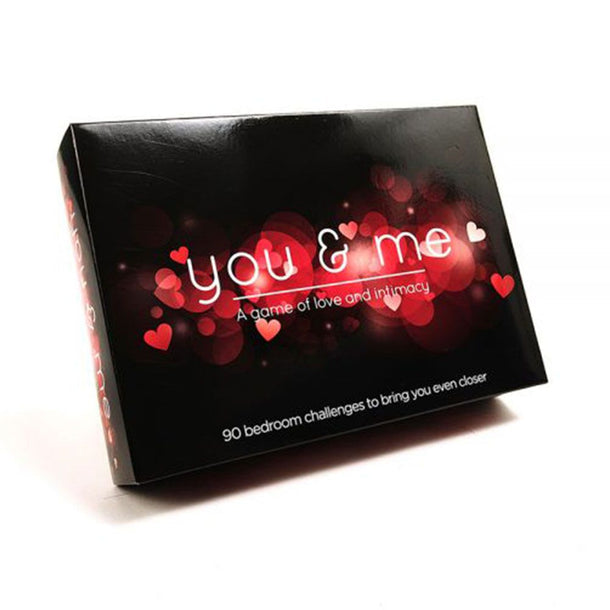 A black box labeled "You and Me - A Game of Love & Intimacy," adorned with red hearts and lights. The bottom reads: "90 bedroom challenges to deepen your connection—ideal for your next date night.