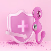 A pink shield with a medical cross and arrow stands beside the Elektra App-Controlled E-Stim Kegel Training Set for Pelvic Floor, featuring pink silicone with silver balls, all set against a pink background scattered with small beads.