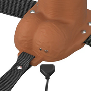 Chocolate Elite Silicone dildo base with vibrating tip, charging port, and black strap-on harness.