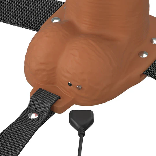 Chocolate Elite Silicone dildo base with vibrating tip, charging port, and black strap-on harness.